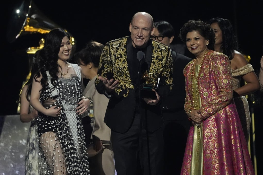(From left) Eru Matsumoto, Wouter Kellerman, and Chandrika Tandon accept the award for best new age, ambient, or chant album for “Triveni” during the 67th Grammy Awards. The album is an example of Hindu devotional singing. Photo: AP