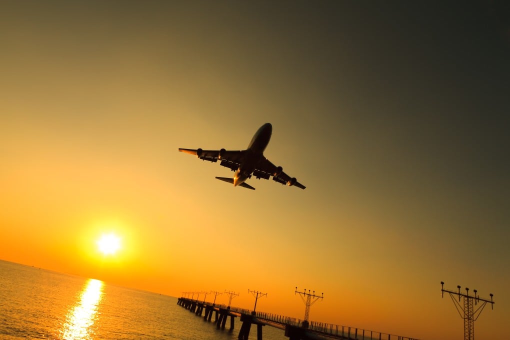 An airplane comes in for a landing at sunset. Photo: Shutterstock