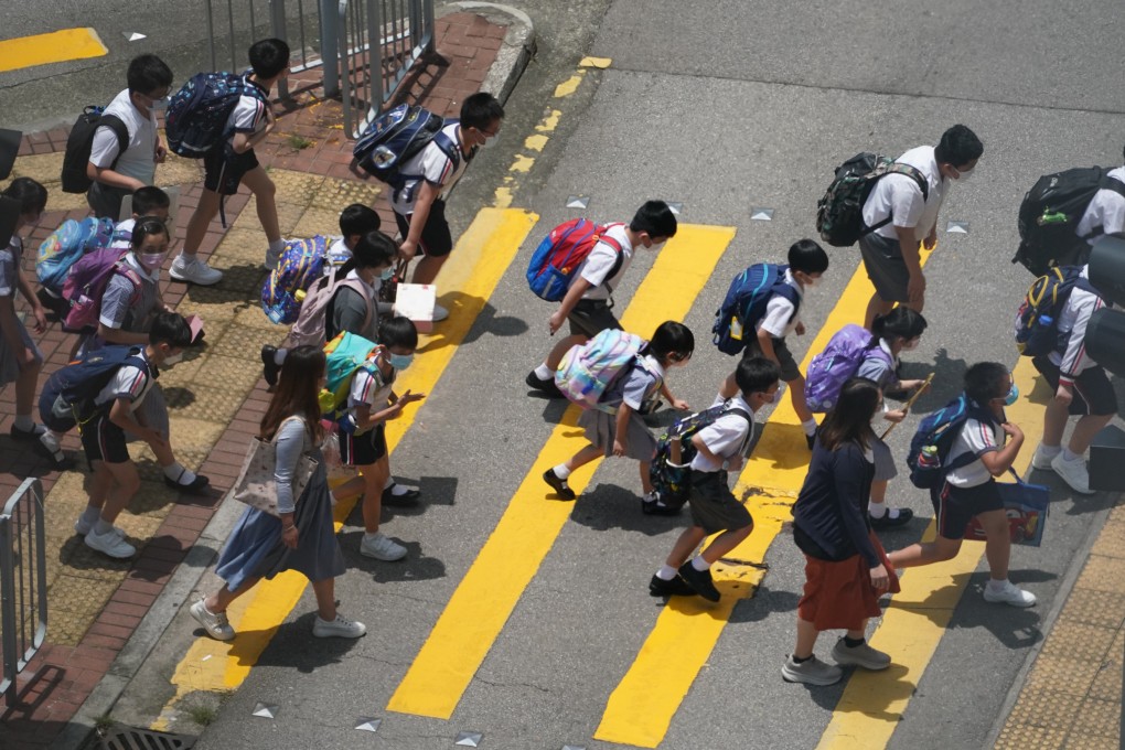 Primary school pupils in Tsuen Wan cross the street. The Education Bureau revealed a breakdown explaining the offences of teachers deregistered. Photo: Felix Wong
