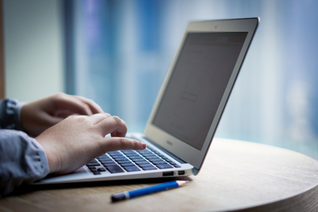 A person using a laptop computer. Photo: Shutterstock