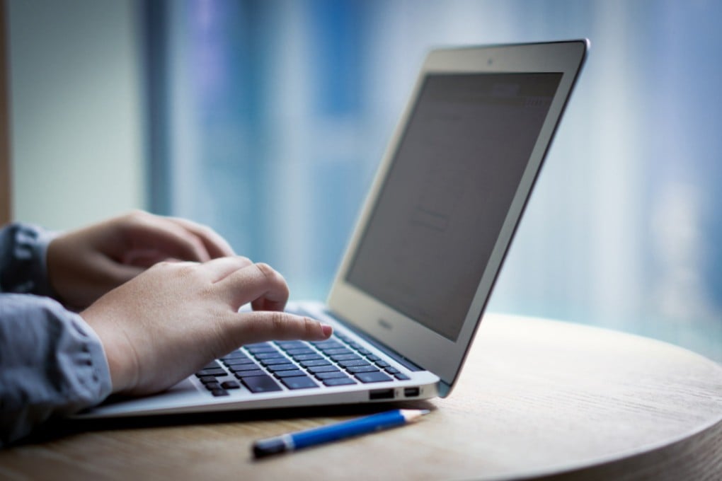 A person using a laptop computer. Photo: Shutterstock