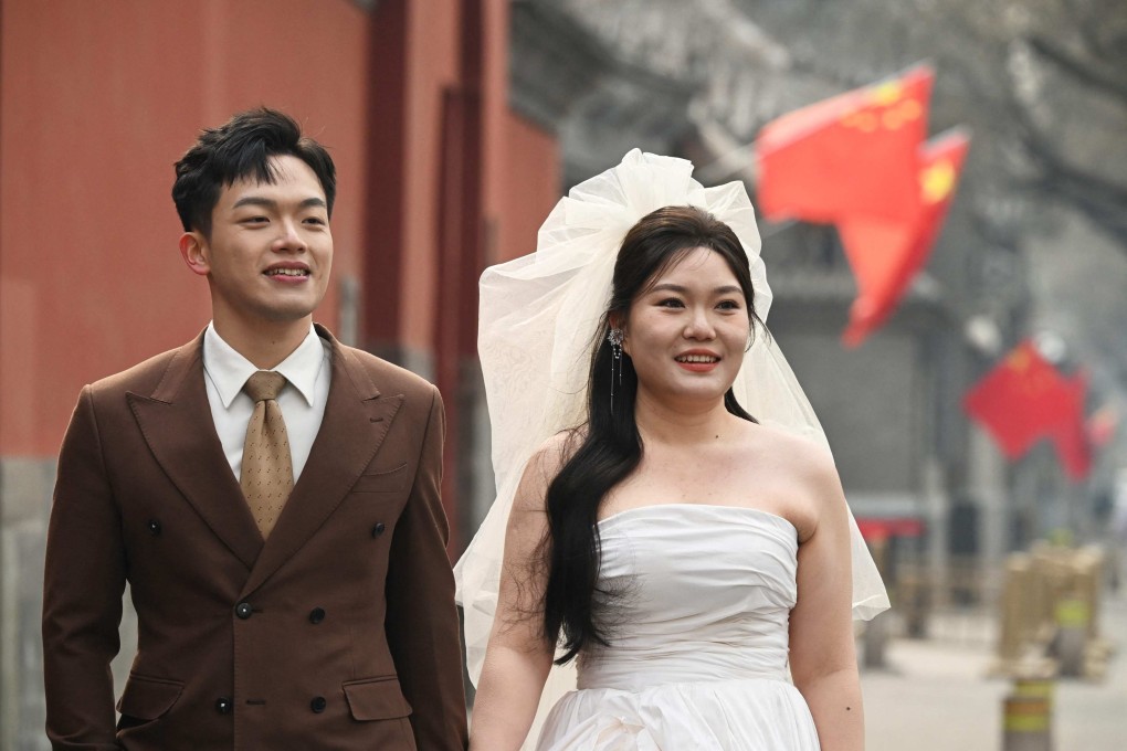 A couple poses for wedding photos on a street near the Forbidden City in Beijing on February 11. Photo: AFP