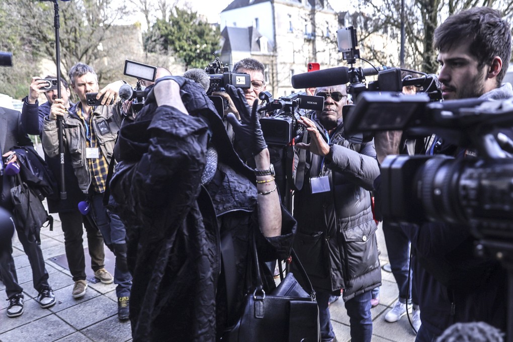 Marie France (front, left), alleged ex-wife of former surgeon Joel Le Scouarnec, is surrounded by journalists upon arrival at the Morbihan criminal court in Vannes, Brittany, France. Photo: EPA-EFE
