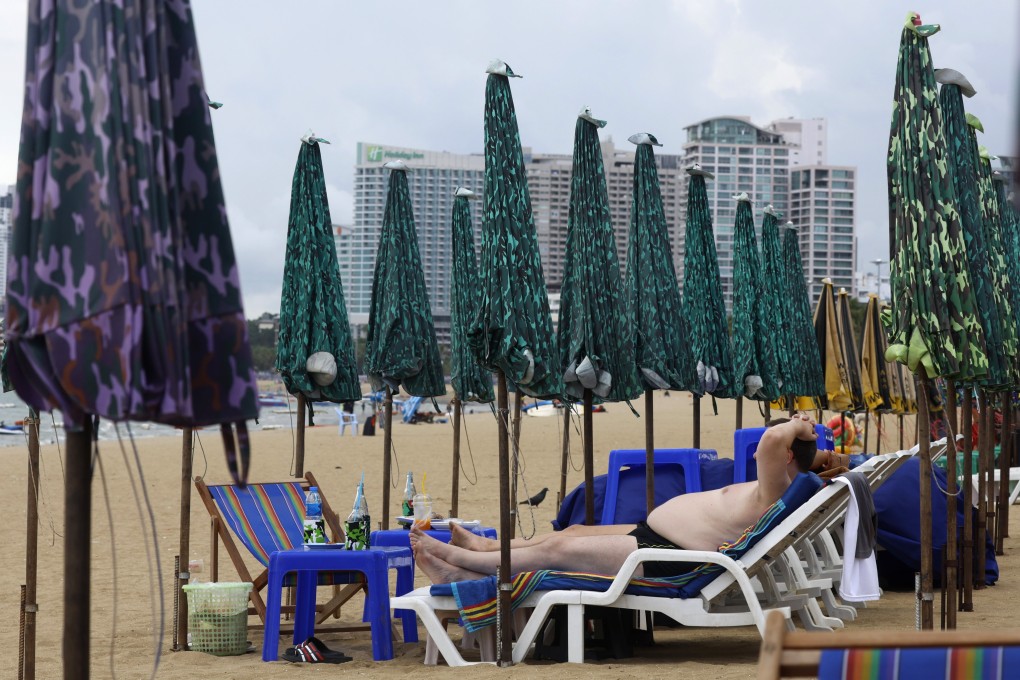 A foreign tourist sunbathes on a beach in Pattaya in Thailand. Photo: EPA-EFE