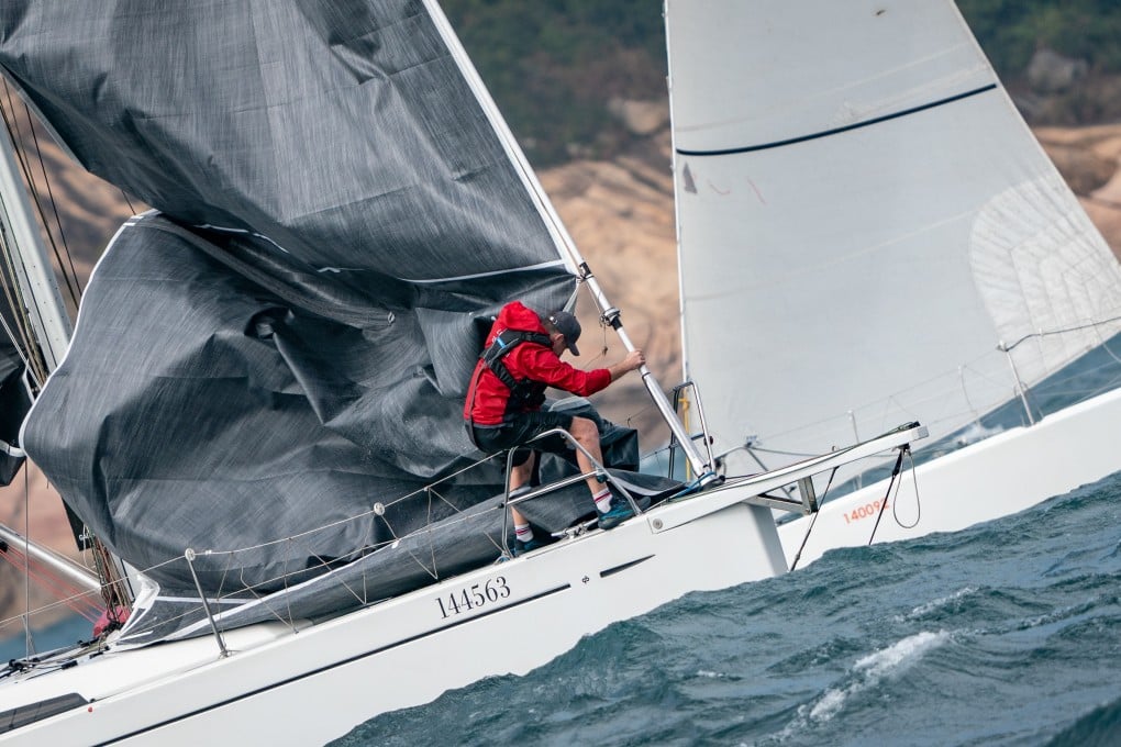 A Four Peaks Race crew member wrestles with one of his yacht’s sails during the race. Photo: Alexander Mak