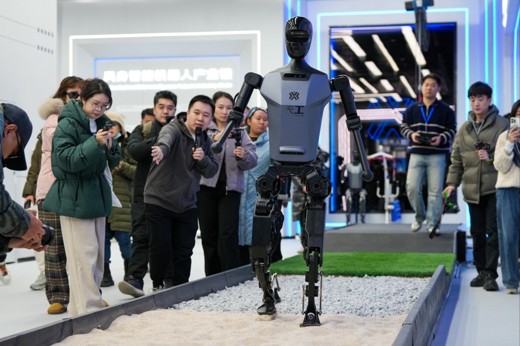 A crowd watches a humanoid robot perform at a trade show in Beijing. China has emerged as a dominant player in the humanoid robot industry in recent years. Photo: Xinhua
