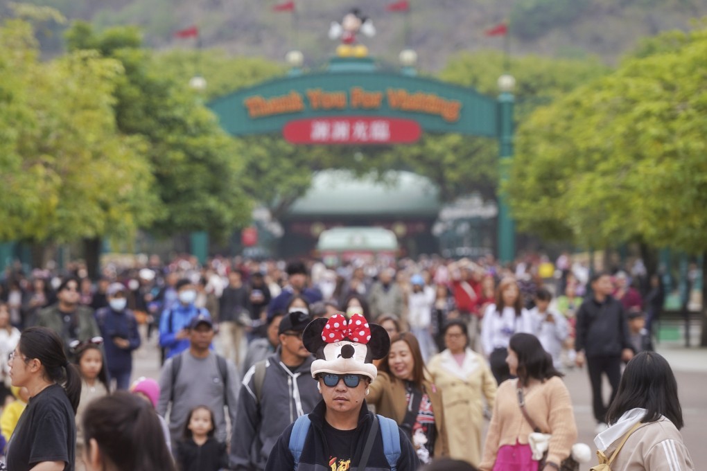 A man wearing a Minnie Mouse accessory on his head is among visitors to Hong Kong Disneyland Resort on February 25. Photo: Elson Li