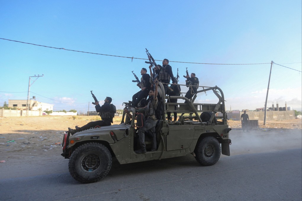 Palestinian militants in the northern Gaza Strip ride an Israeli military vehicle that was seized by gunmen who infiltrated southern Israel on October 7, 2023. File photo: Reuters