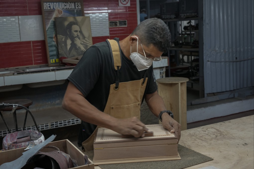 An artisan builds a cigar humidor at the Humidors Habana Art Creation Workshop, in Havana, Cuba. The boxes that hold cigars can be highly elaborate and sell for thousands of dollars. Photo: AP