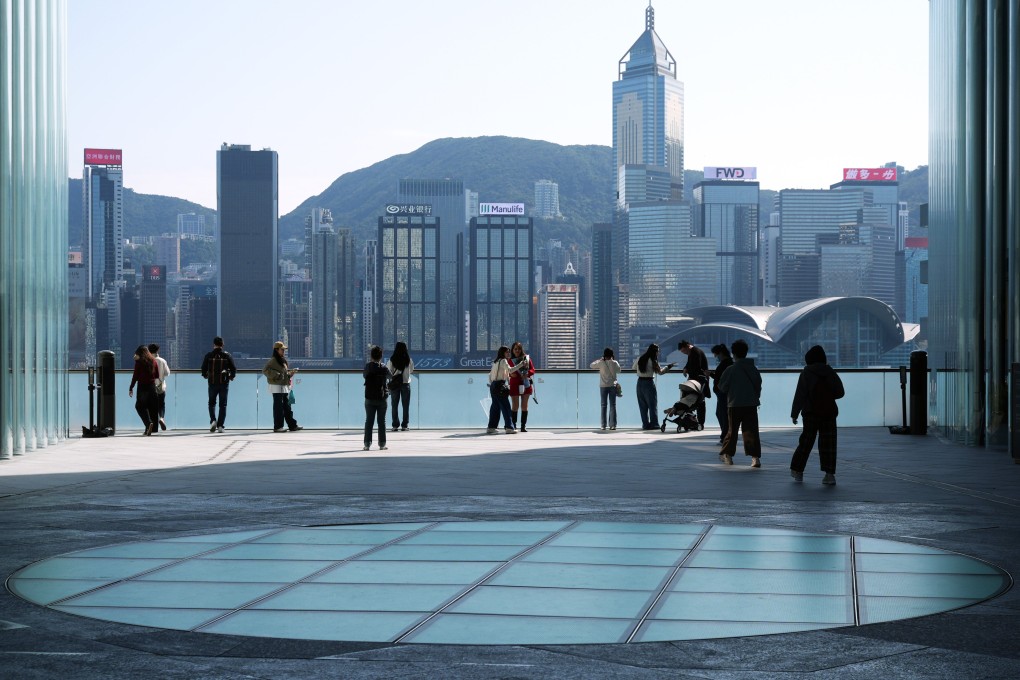 People gaze across Victoria Harbour from Kowloon. Photo: Eugene Lee
