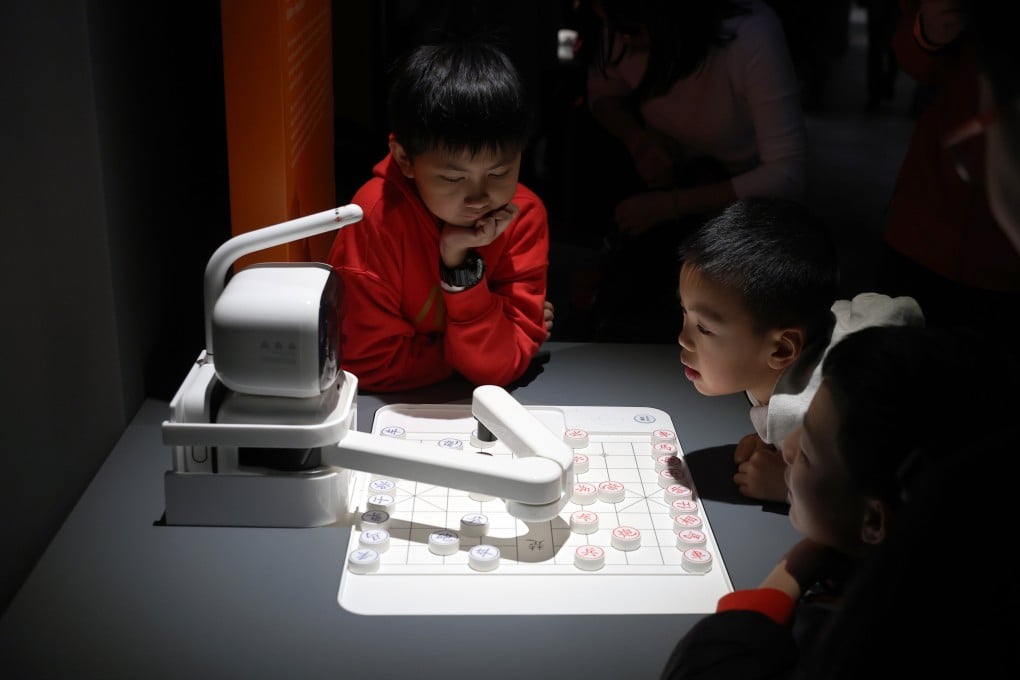 Children gathered around an AI chess player in an exhibition on China’s developments over the past 75 years, at the Hong Kong Science Museum in Tsim Sha Tsui on February 3. Photo: Edmond So