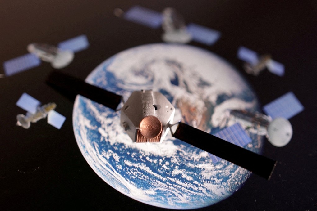 A satellite model is placed on a picture of Earth in this illustration taken. Photo: Reuters