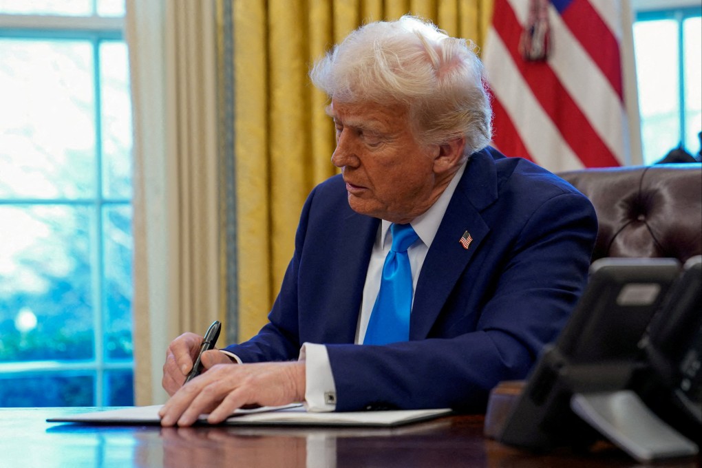 US President Donald Trump signs a document in the Oval Office on February 4. Photo: Reuters