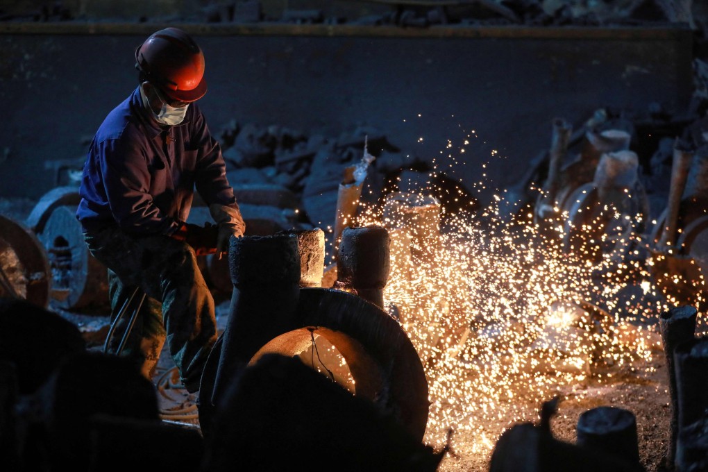 A worker polishes machinery in a factory in Hangzhou, China. Photo: AFP