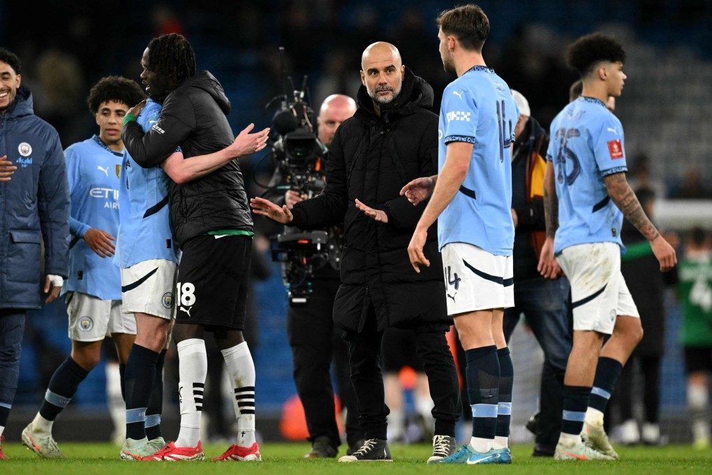 Manchester City boss Pep Guardiola celebrates with his players after their FA Cup fifth-round victory over Plymouth Argyle. Photo: AFP