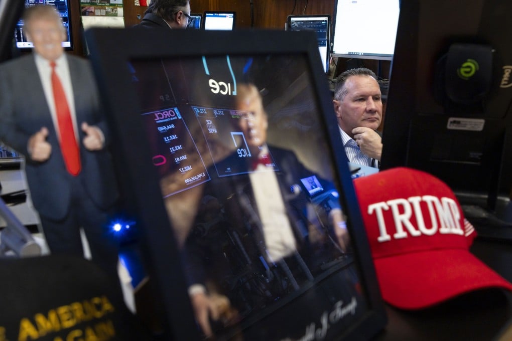 A trader works with an assembly of US President Donald Trump paraphernalia seen in the foreground on the floor of the New York Stock Exchange on February 28. Photo: EPA-EFE