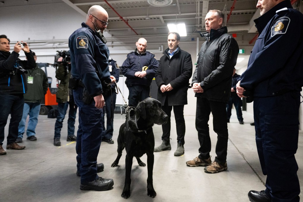 Canada’s Public Safety Minister David McGuinty (right) stands next to a narcotics detection dog in Ontario on February 12. Photo: The Canadian Press via AP