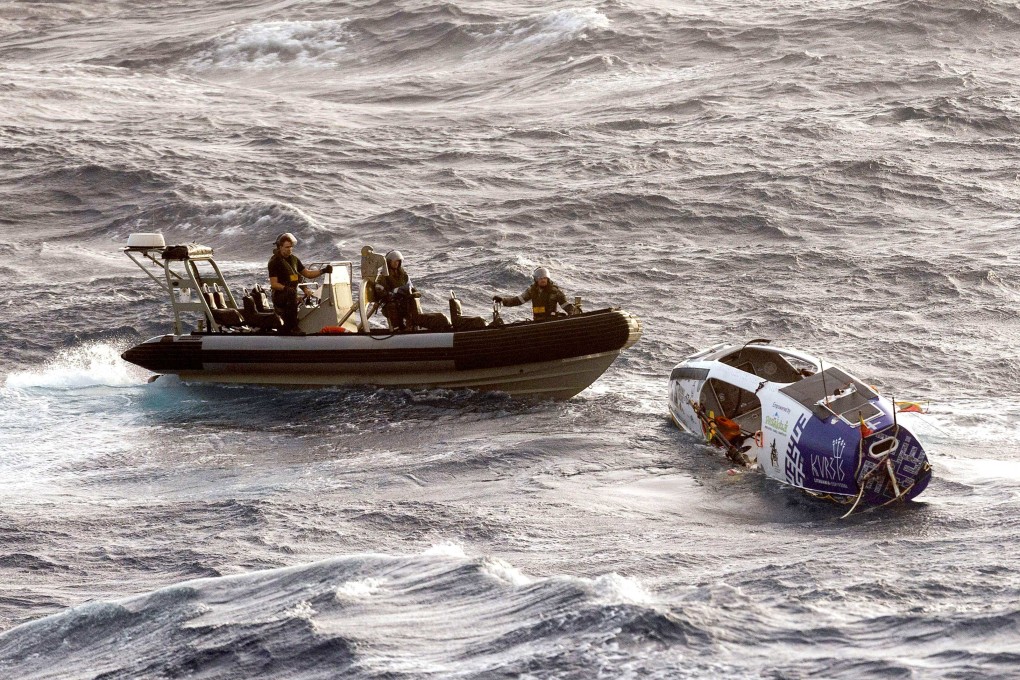 Sailors from the Royal Australian Navy rescue Lithuanian long-distance rower Aurimas Mockus from storm-tossed seas off Australia on Monday. Photo: AFP