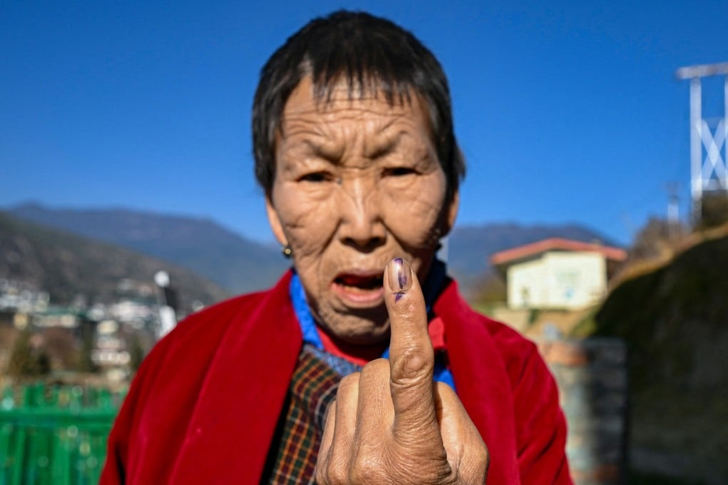 A Bhutanese voter shows an indelible ink mark on her finger after casting her vote at a polling station in Thimphu during general elections in January 2024. Photo: AFP