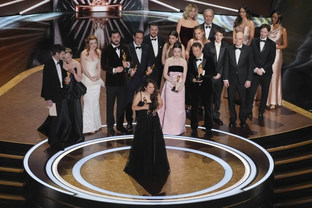 Samantha Quan (front, centre) accepts the award for best picture for Anora during the Oscars ceremony at the Dolby Theatre in Los Angeles. Behind her (centre) are best actress winner Mikey Madison, in pink, and to her left, director Sean Baker. Photo: AP