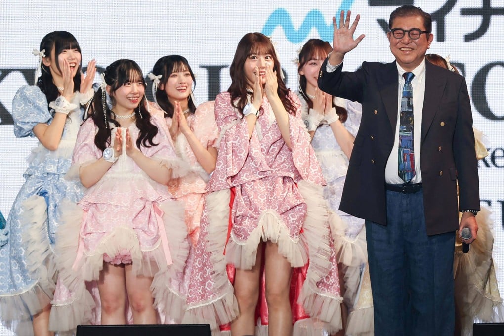Models reacts to Japanese Prime Minister Shigeru Ishiba’s outfit at the Tokyo Girls Collection fashion event on Saturday. Photo: Jiji Press/AFP