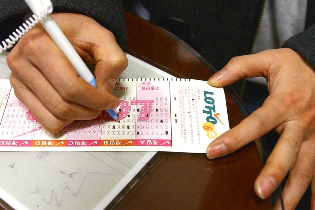 A man marks numbers on a lottery ticket in Seoul. Photo: AFP