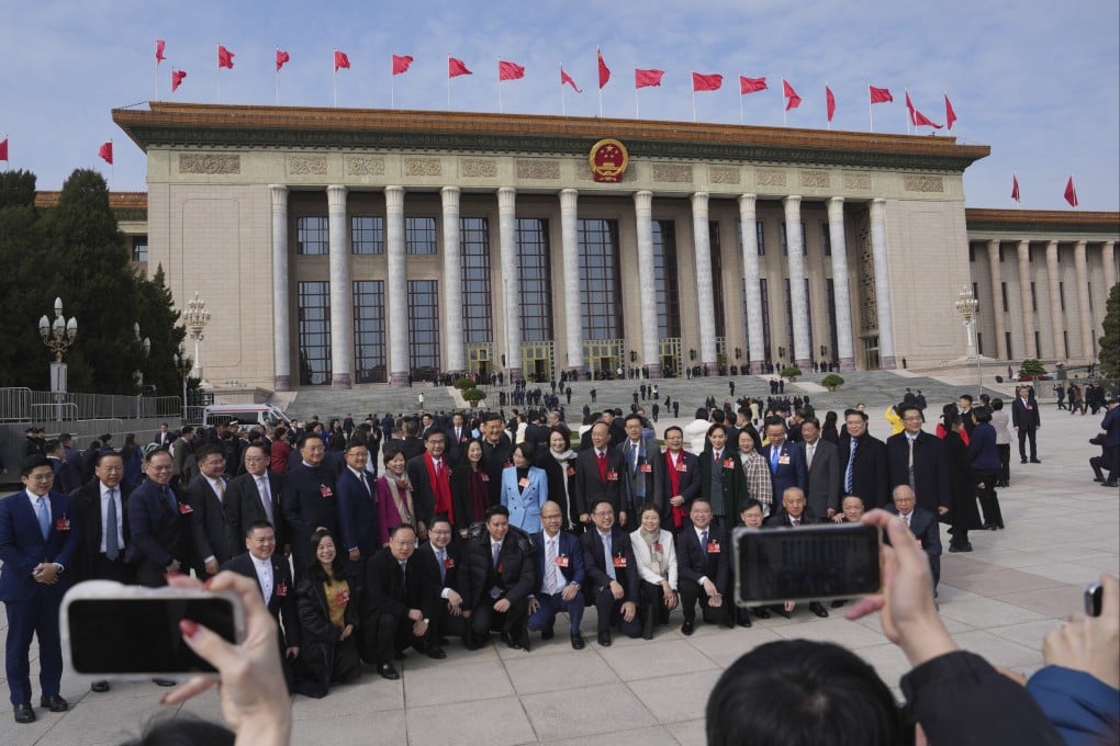 Members of the Hong Kong delegation gather for a group photo on Tuesday before the opening of the two sessions at the Great Hall of the People in Beijing. Photo: AP