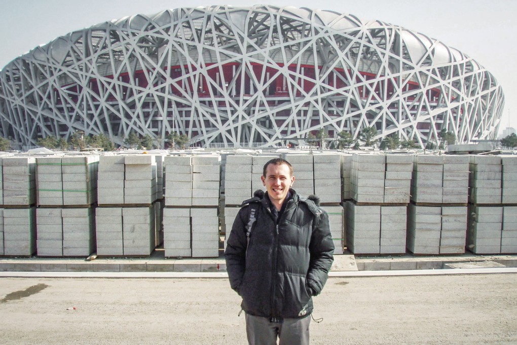 Glen Loveland poses in front of Beijing’s Olympic Stadium. Photo: Courtesy of Glen Loveland