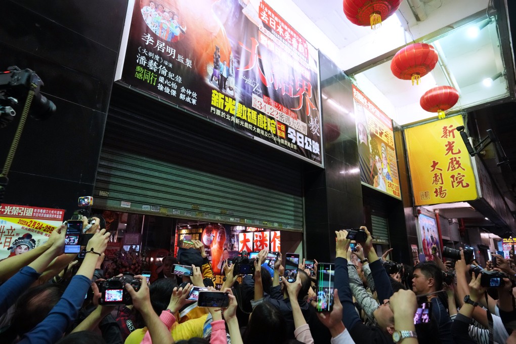 Residents snap photos as the shutters come down on Sunbeam Theatre. Photo: Sam Tsang