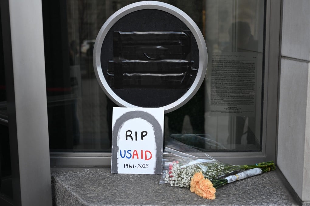 A sign and flowers lay near the entrance of the US Agency for International Development (USAID) headquarters in Washington on 07 February 2025. Following the Trump administration reorganization plans, spearheaded by billionaire Elon Musk, around 300 members were expected to remain out of the USAID’s worldwide total of more than 10,000. Photo: EPA-EFE
