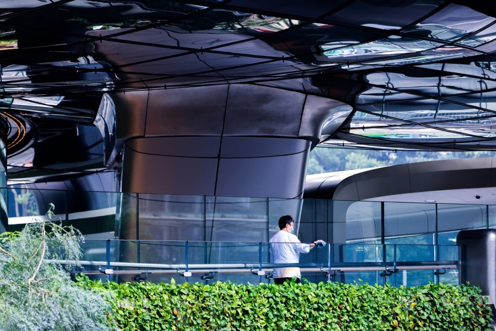 A cleaner wipes handrail at a commercial building in Central, Hong Kong. Photo: Nora Tam
