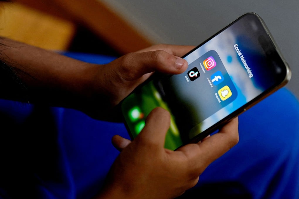 A student in Melbourne, Australia, looks at her mobile phone showing social media applications. Photo: Reuters