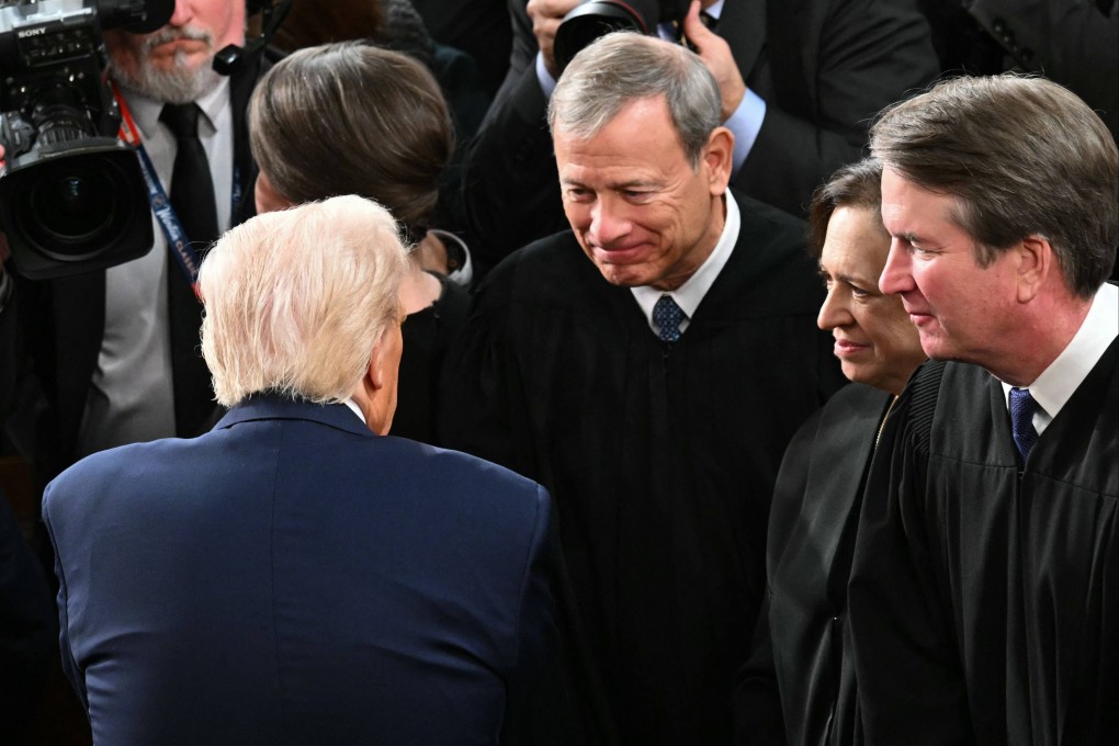 US President Donald Trump greets Supreme Court Chief Justice John Roberts as Trump departs after giving an address to a joint session of Congress in the US Capitol. Photo: AFP
