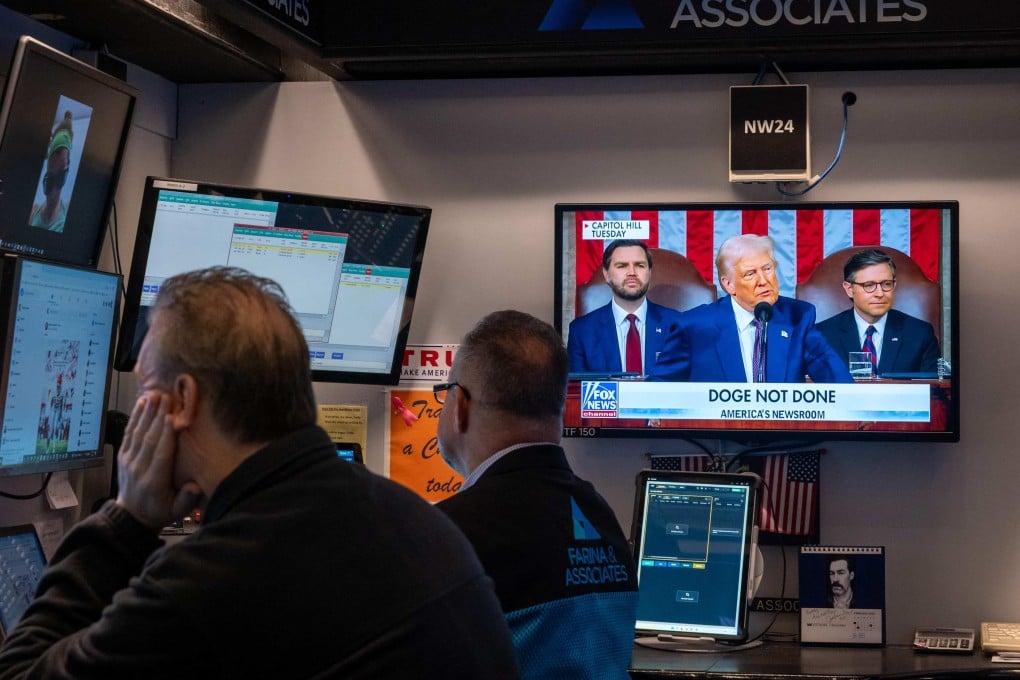 Traders work on the floor of the New York Stock Exchange on March 5, as Donald Trump appears on a television screen. Photo: AFP