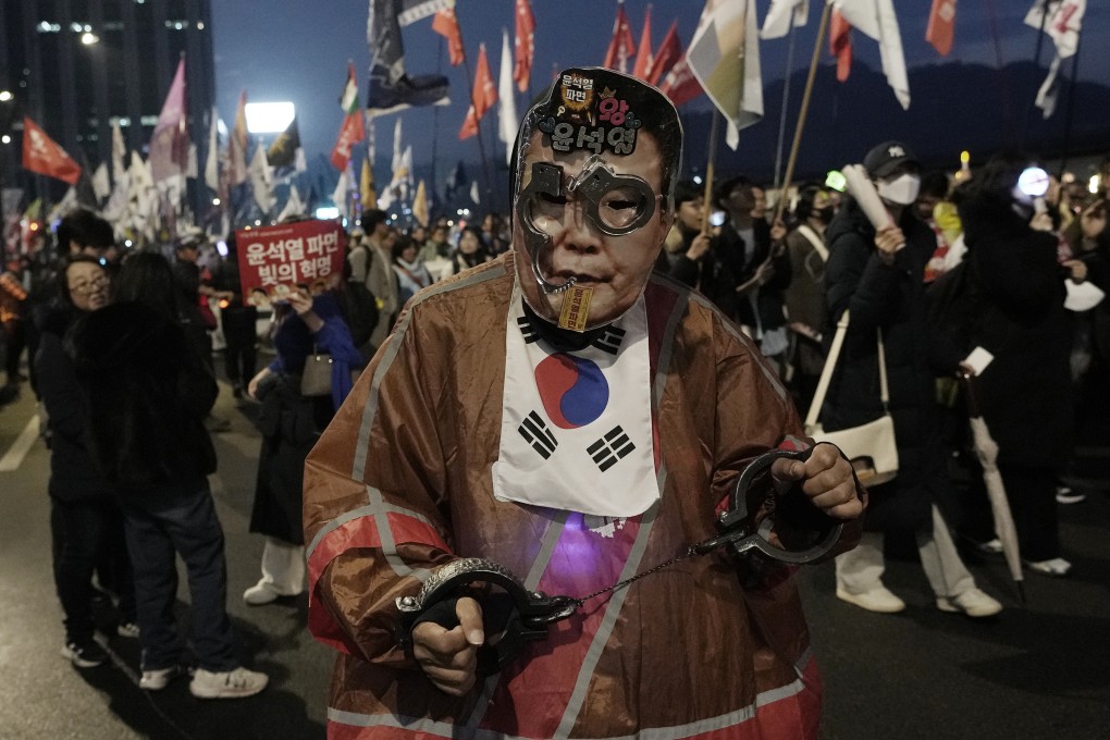 A protester wearing a mask of South Korea’s suspended president Yoon Suk-yeol takes part in a rally in Seoul on March 1. Photo: AP
