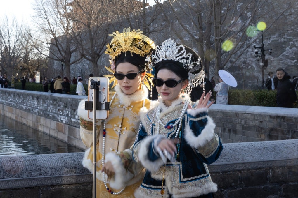 Women in period costume record a dance with a phone in Beijing on February 25. Photo: EPA-EFE