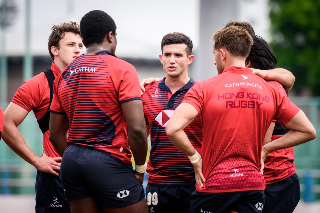 Jack Combes (centre) leads a discussion with his Hong Kong sevens teammates. Photo: HKCR