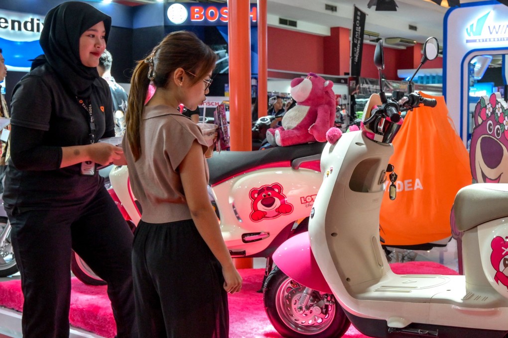 Visitors admire two-wheeled EVs at a motor show in Indonesia last month. Photo: AFP
