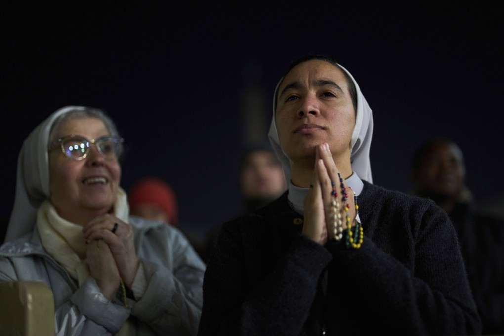 Catholic nuns listen to a recorded message from Pope Francis in St Peter’s Square at The Vatican. Photo: AP