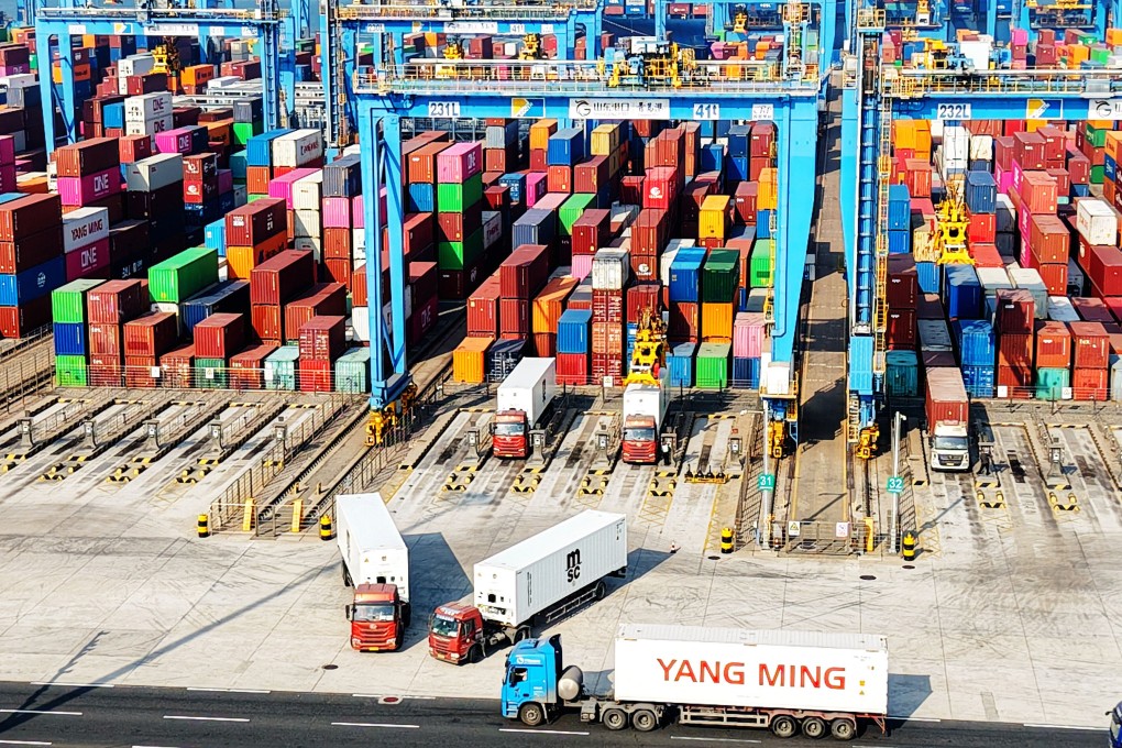 Trucks transport containers at a port in eastern China’s Shandong province. China posted a record trade surplus in 2024 as exports surged in several industries. Photo: Getty Images