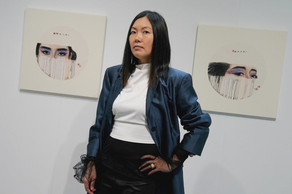 Artist Hong Wai poses with paintings inspired by late Hong Kong singer Anita Mui’s heavily made up eyes, part of her exhibition at Soho House in the city’s Sheung Wan neighbourhood. Photo: Elson Li