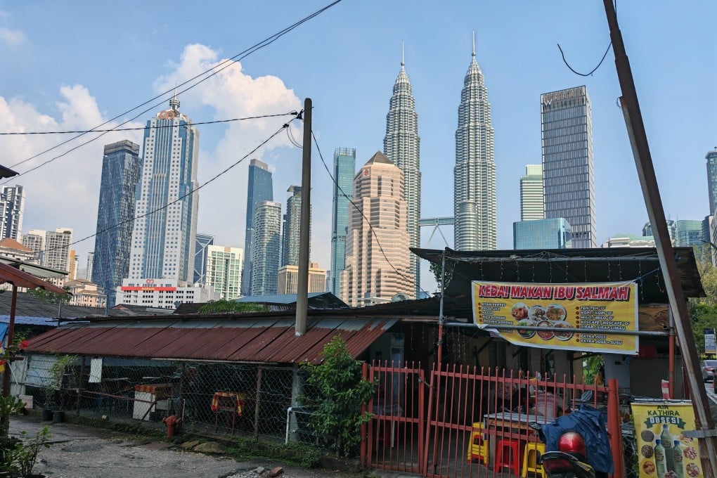Kuala Lumpur’s KLCC Twin Towers and other skyscrapers are seen surrounding Kampung Baru, the city’s last traditional Malay village. Photo: Joseph Sipalan