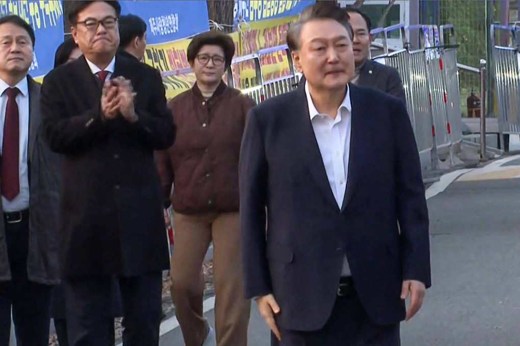 Impeached South Korean President Yoon Suk-yeol (right) walking out of the Seoul Detention Center in Uiwang after he was released on Saturday. Photo: AFP