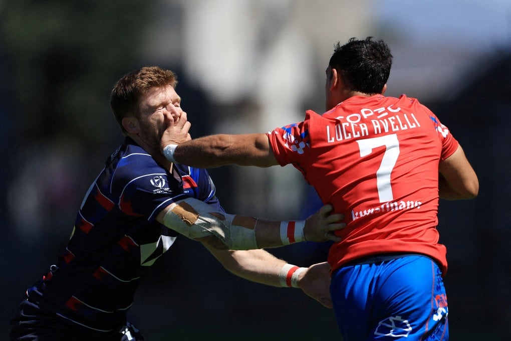 Liam Herbert takes a blow to the face from Chile’s Lucca Avelli on a bruising day for Hong Kong rugby. Photo: Reuters