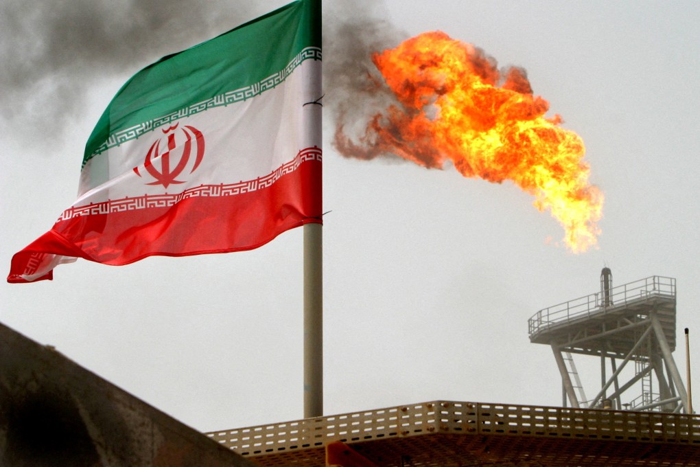 A gas flare on an oil production platform is seen alongside an Iranian flag in the Gulf. Photo: Reuters