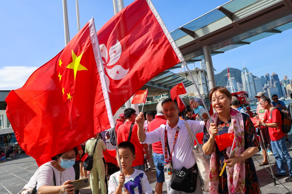 People celebrate National Day at the Tsim Sha Tsui waterfront. Hong Kong has been urged to further develop itself to benefit the rest of the nation. Photo: Jelly Tse