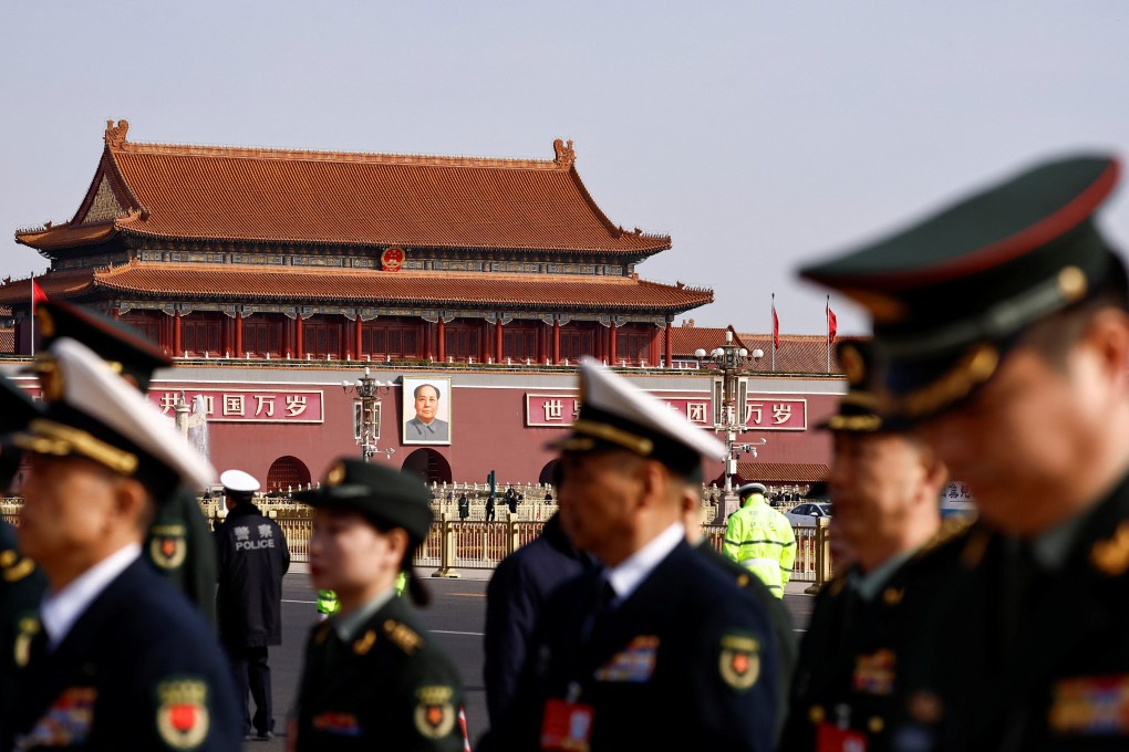 Military delegates walk past Tiananmen Square ahead of the National People’s Congress. Photo: Reuters