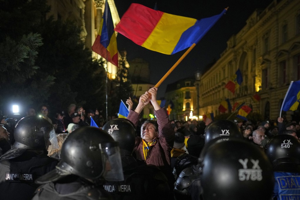A supporter of Calin Georgescu during a protest in Bucharest, Romania, on Sunday. Photo: AP