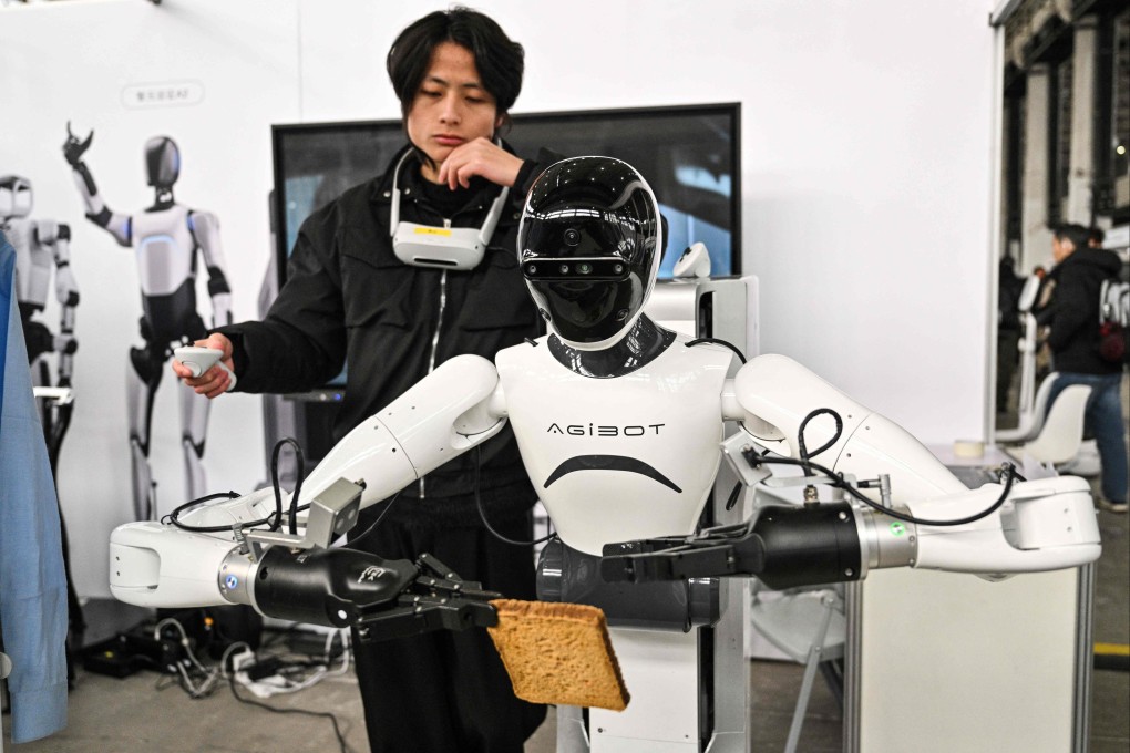 A man controls an Agibot robot at the Global Developer Conference, organised by the Shanghai AI Industry Association, in Shanghai in February. Photo: AFP