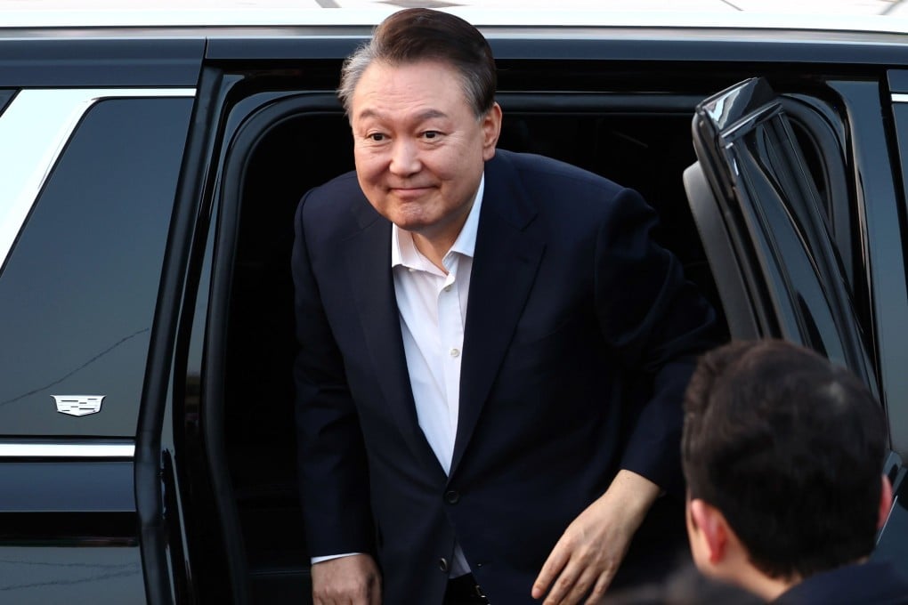 Yoon Suk-yeol exits a vehicle on Saturday as he arrives in front his official residence in Seoul after being released from detention. Photo: Yonhap/EPA-EFE